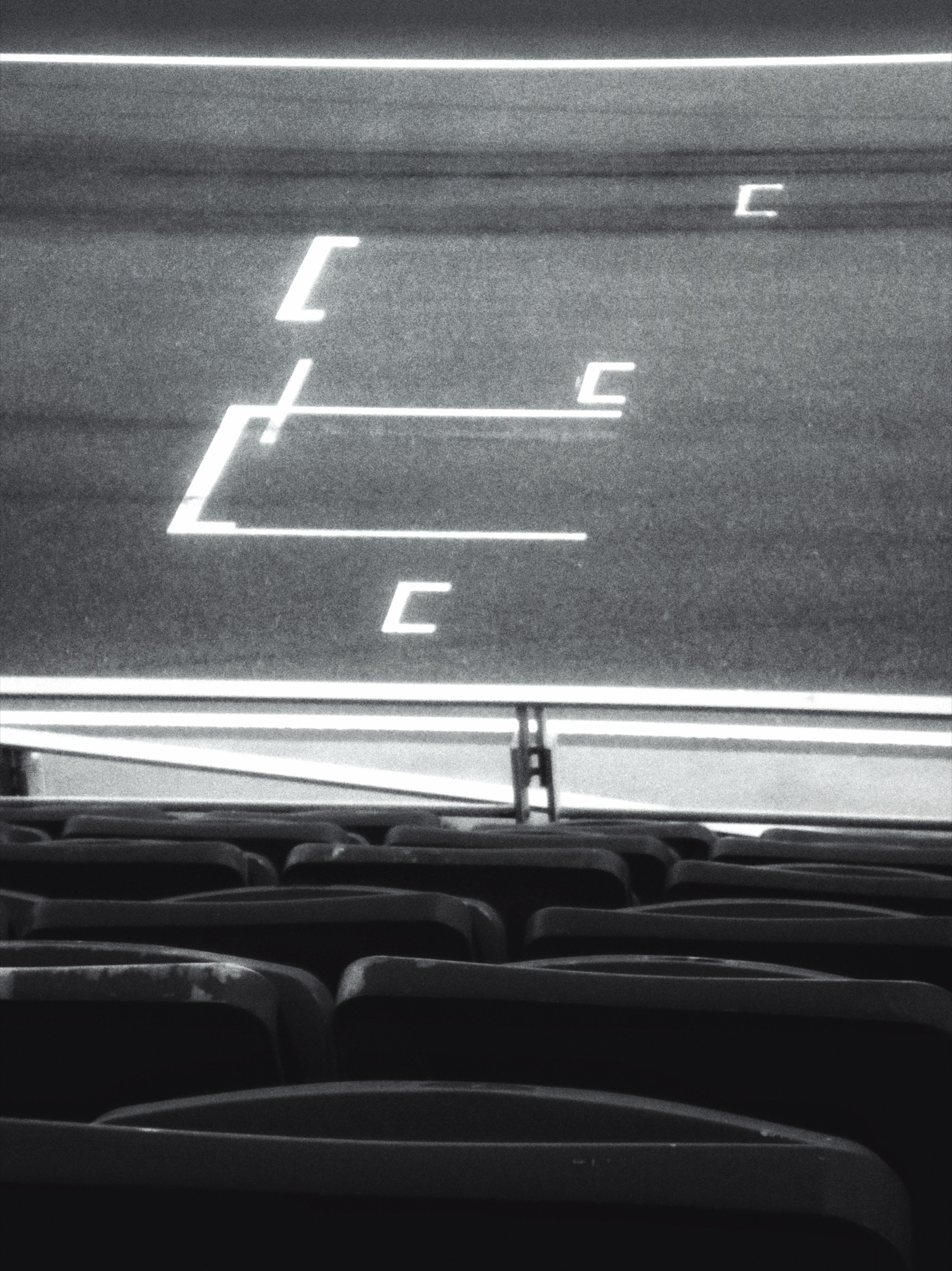 Grainy black and white abstract study of illuminated signage