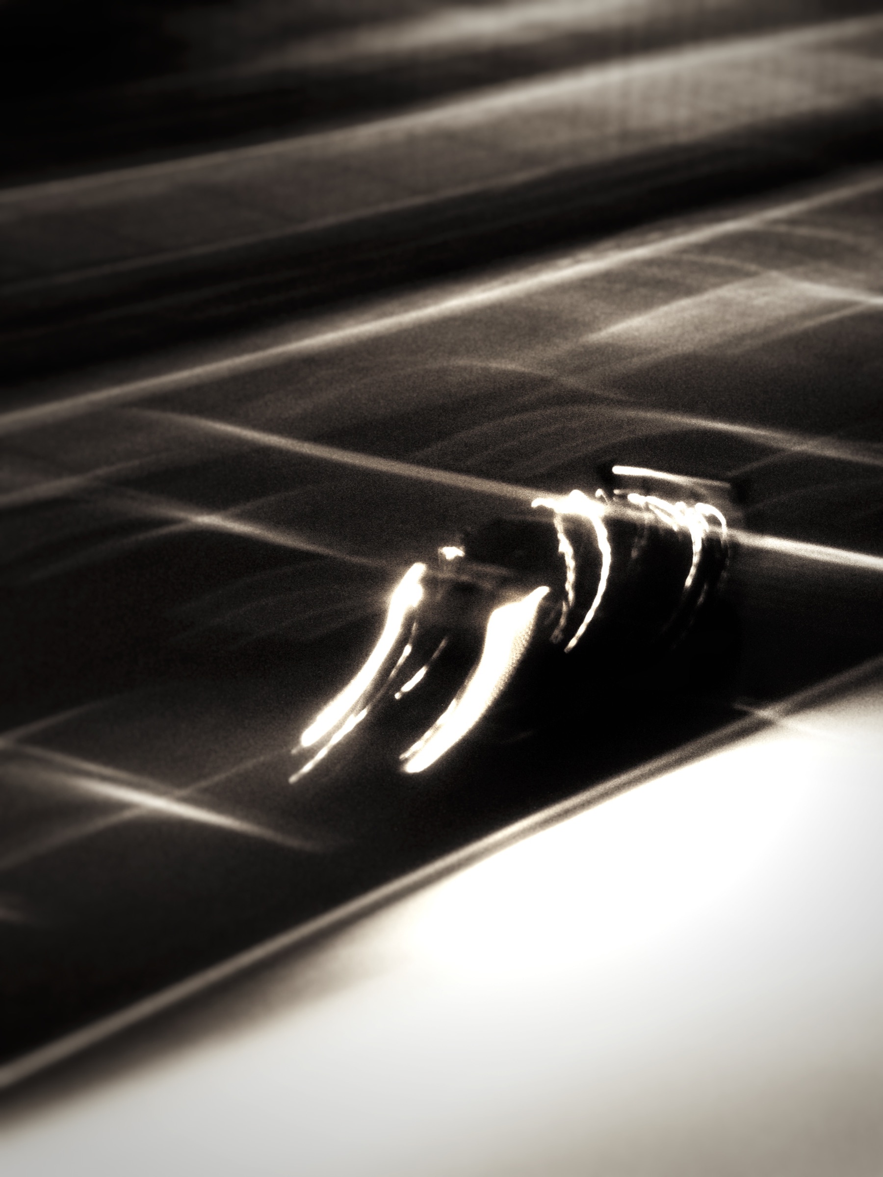 Sepia-toned motion blur study of a car detail