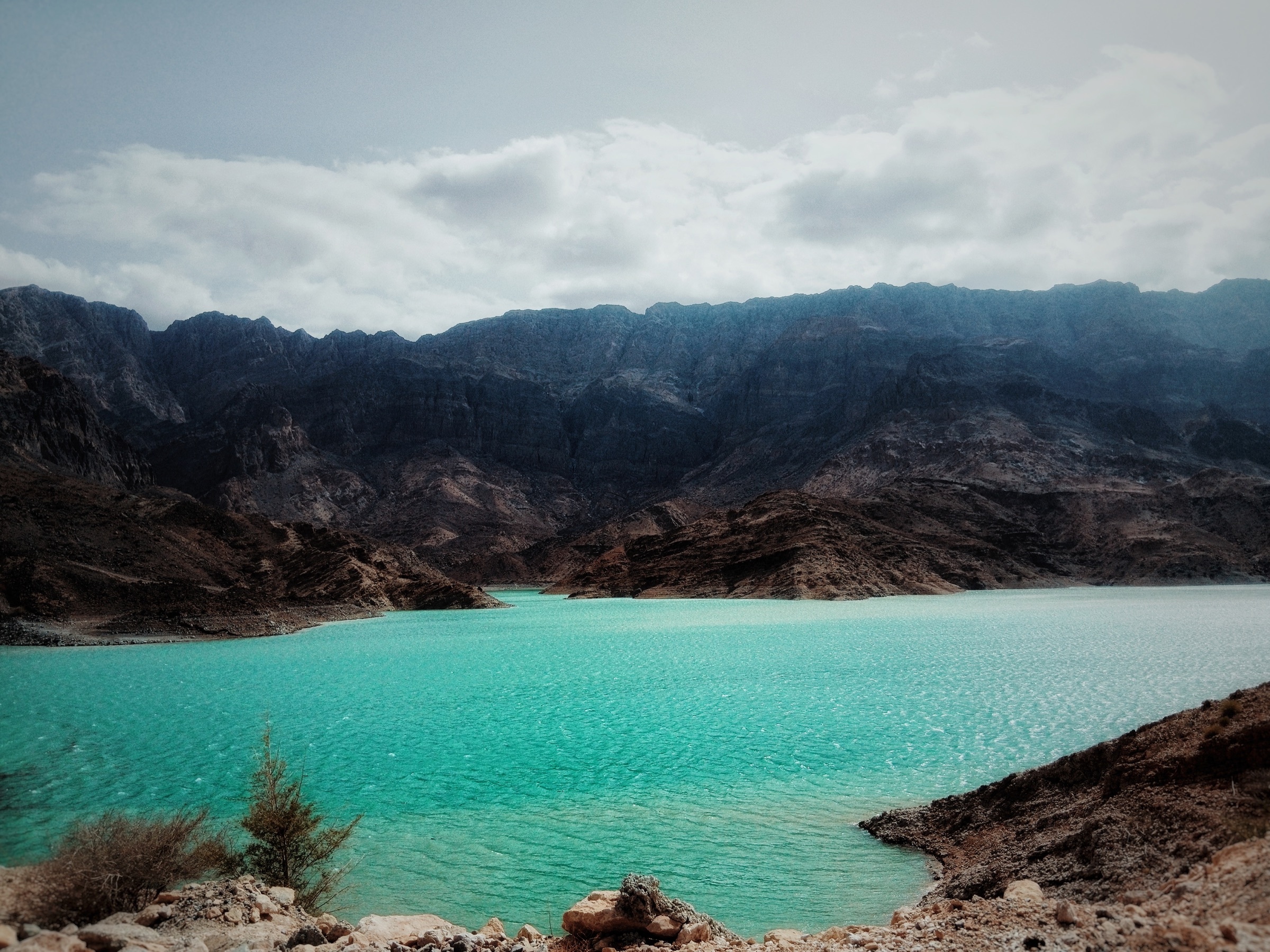 Turquoise lake against dark mountains