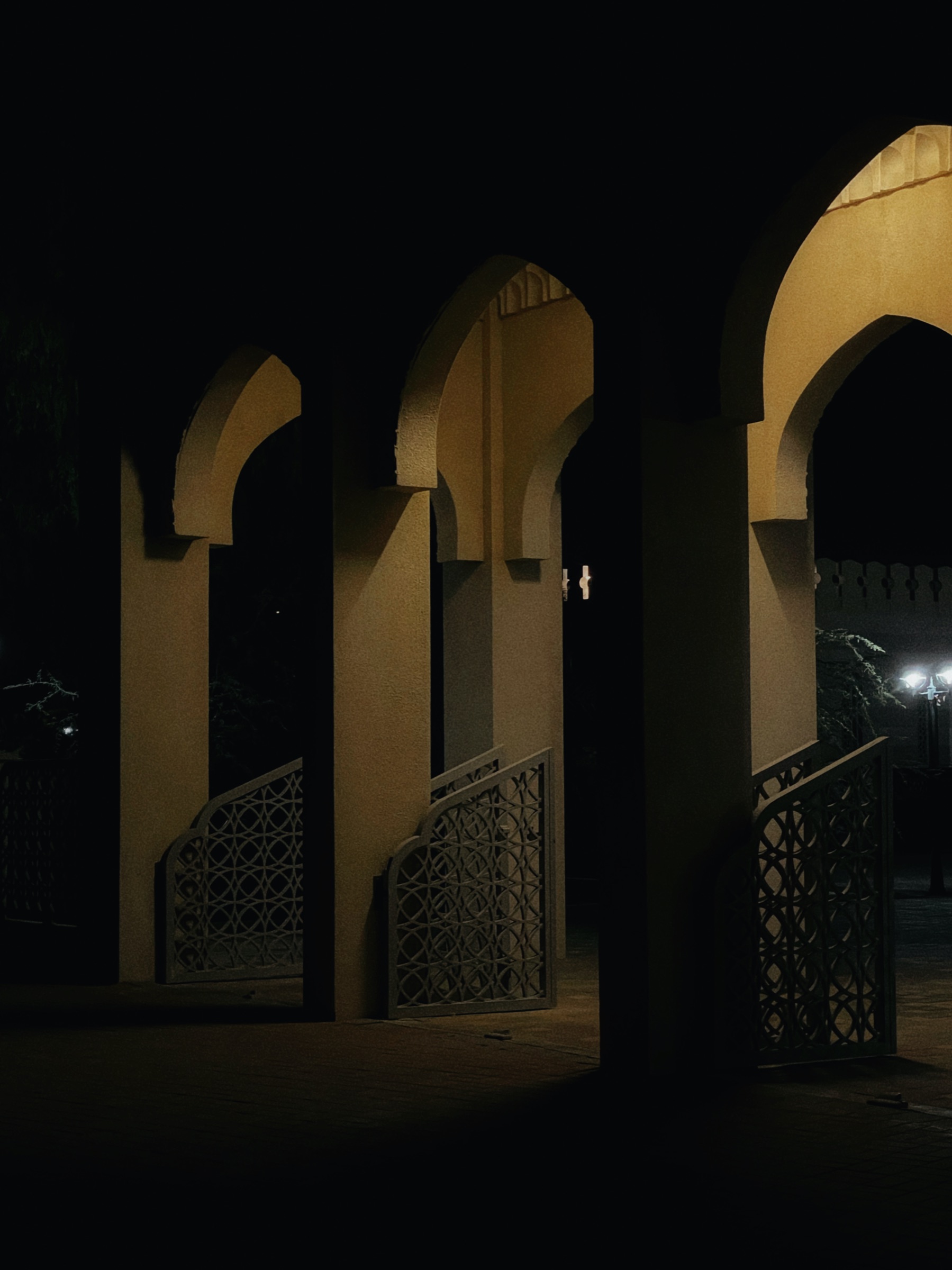 Arched geometric screens lit at night