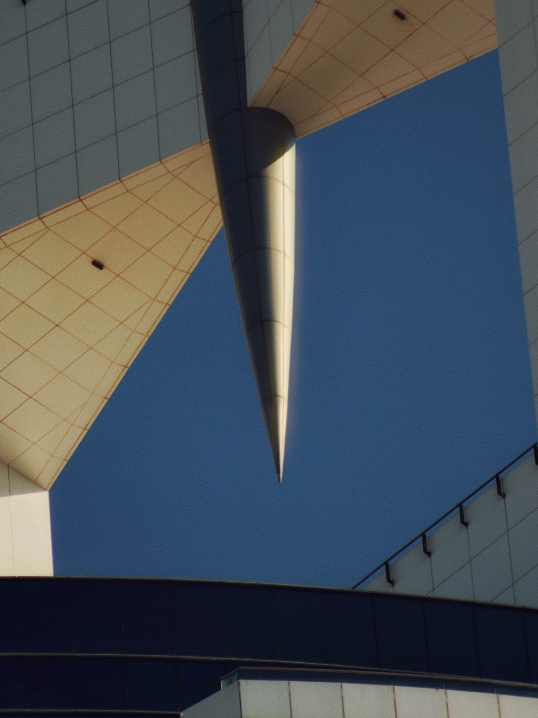 Triangular building facade against a clear sky