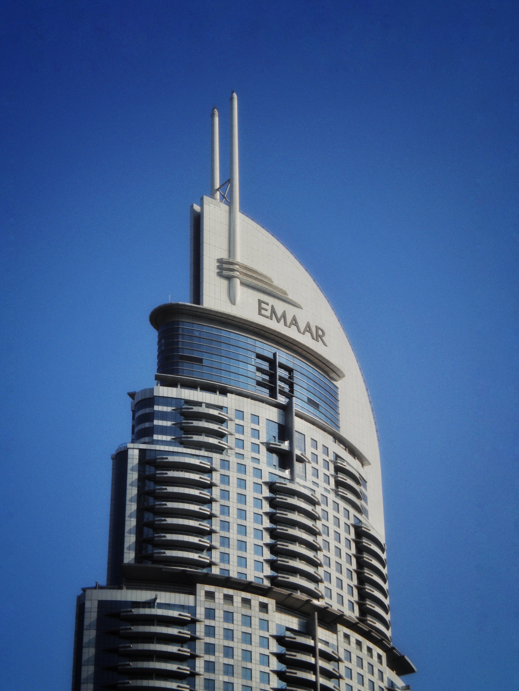Building spire against deep blue sky