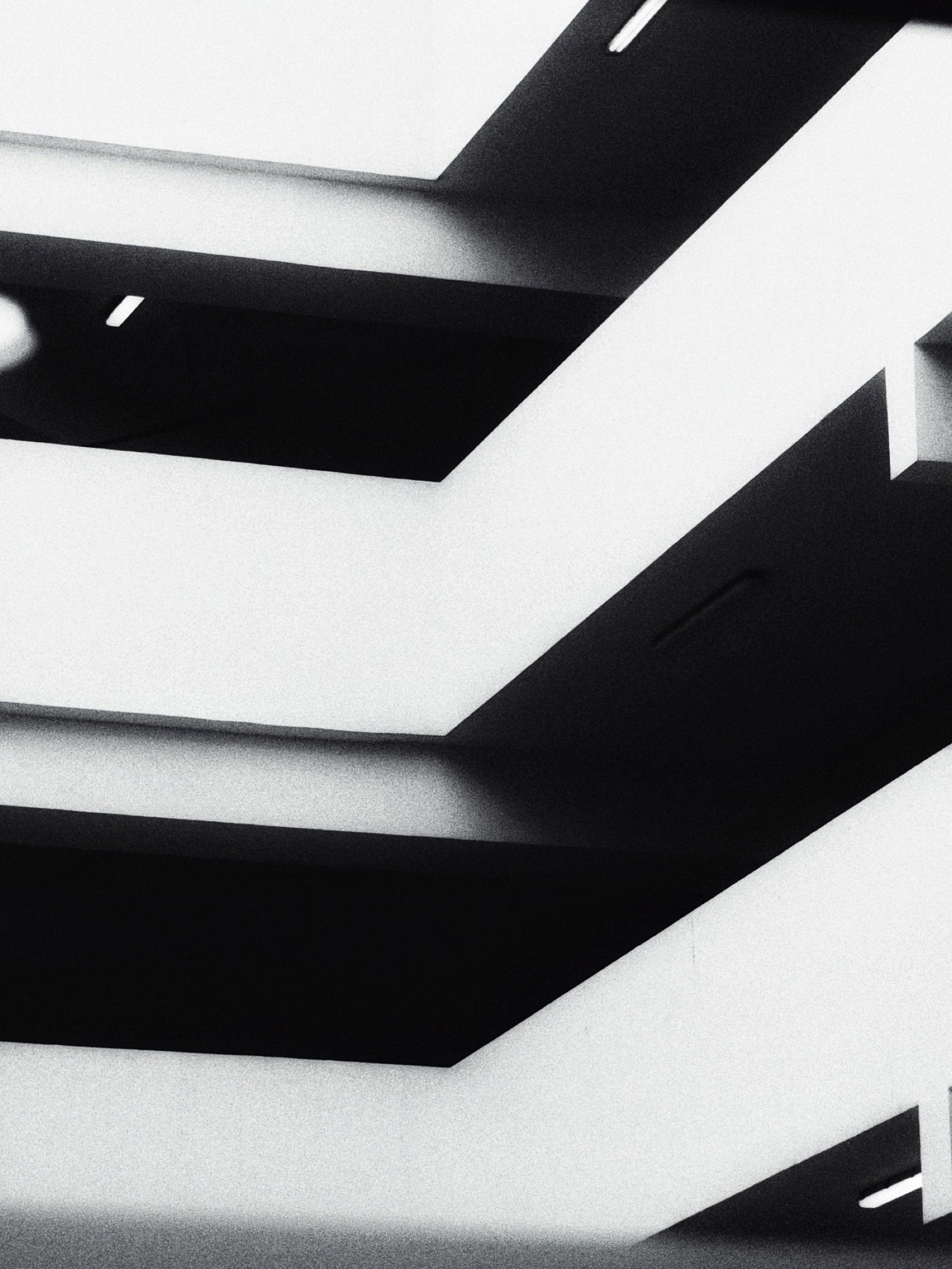 Black and white abstract study of angular staircase geometry