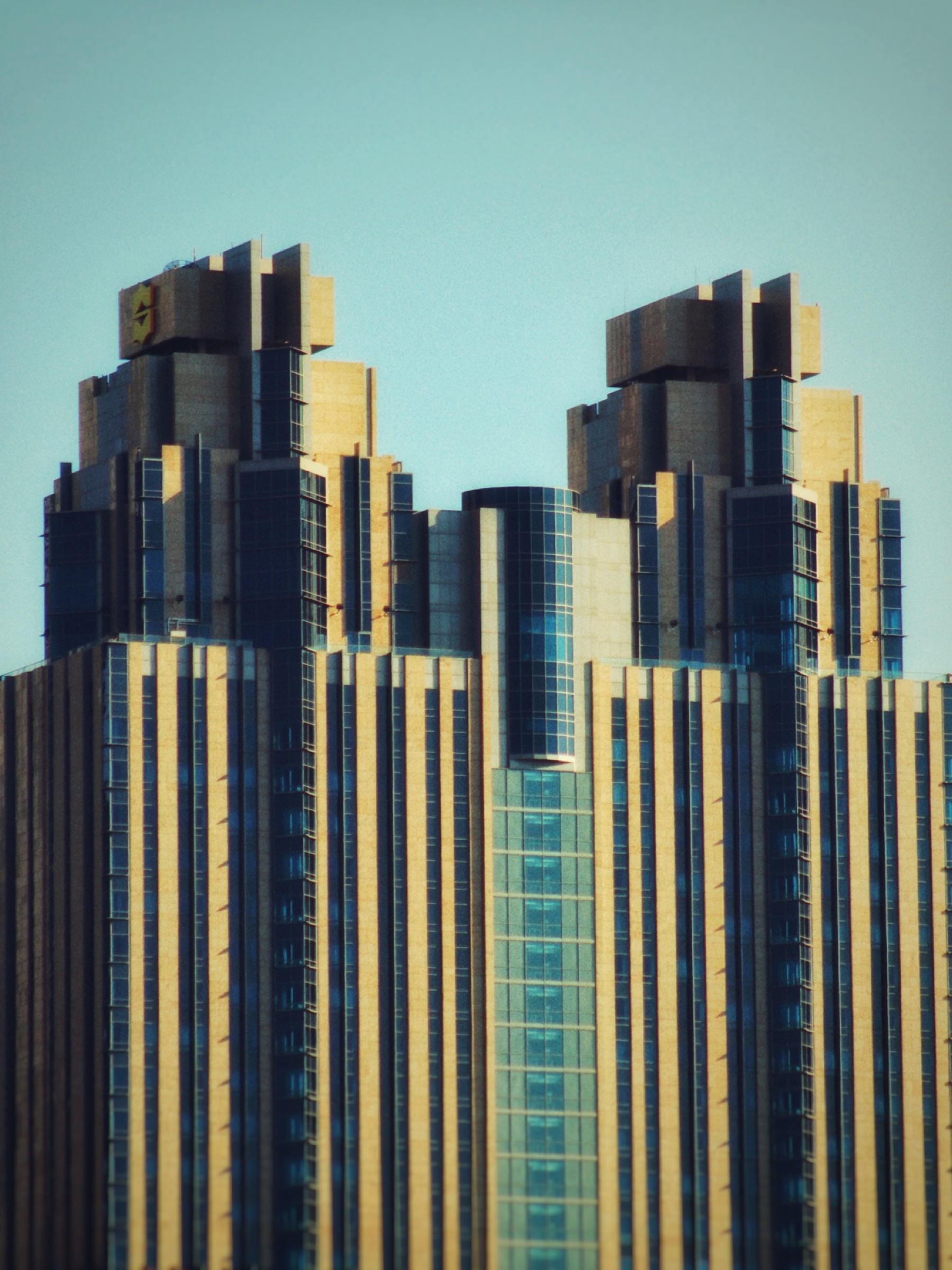 Twin symmetrical towers with gold and blue facades