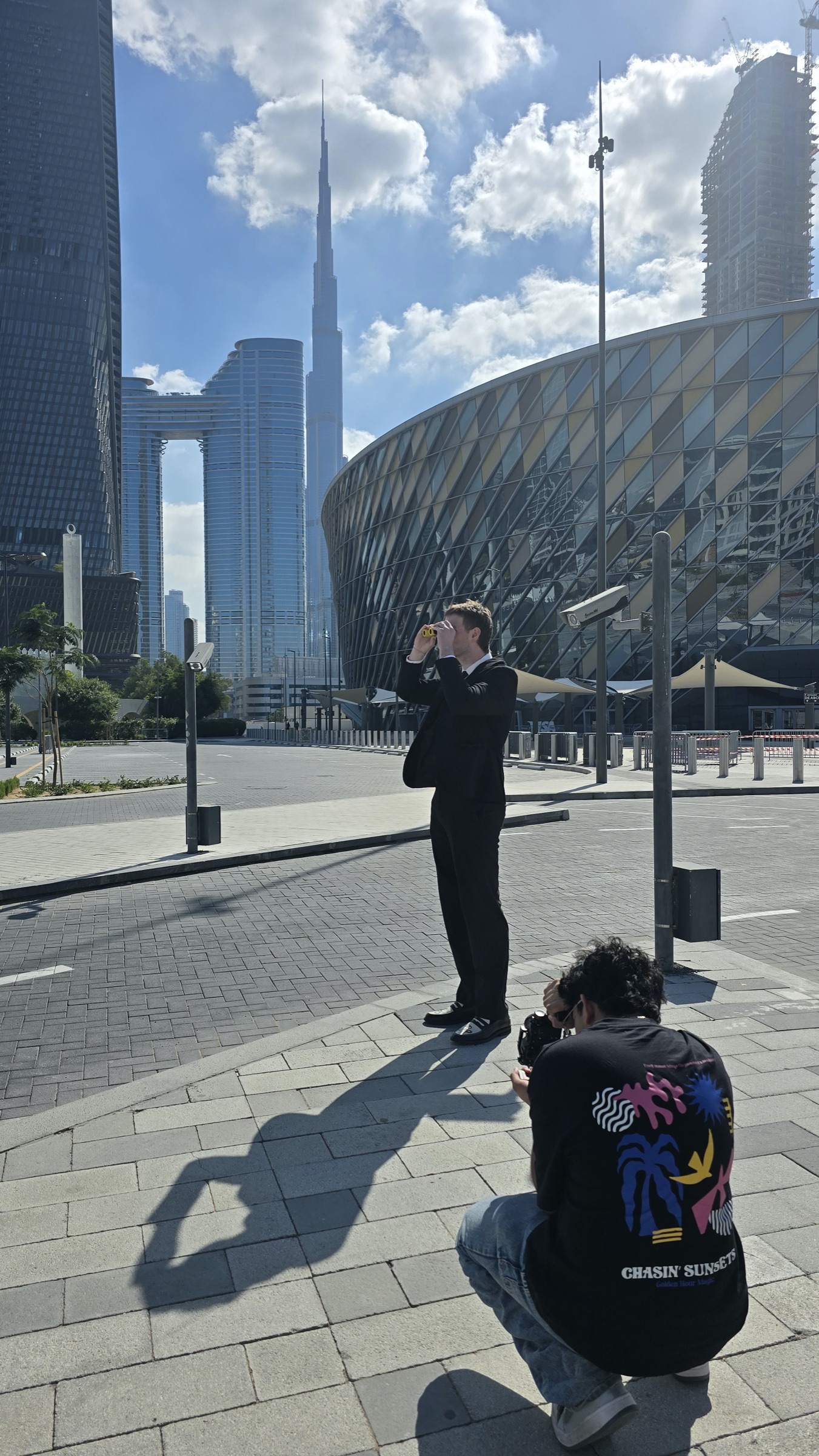 Raashid Ambel filming on location in Dubai, Burj Khalifa in the background