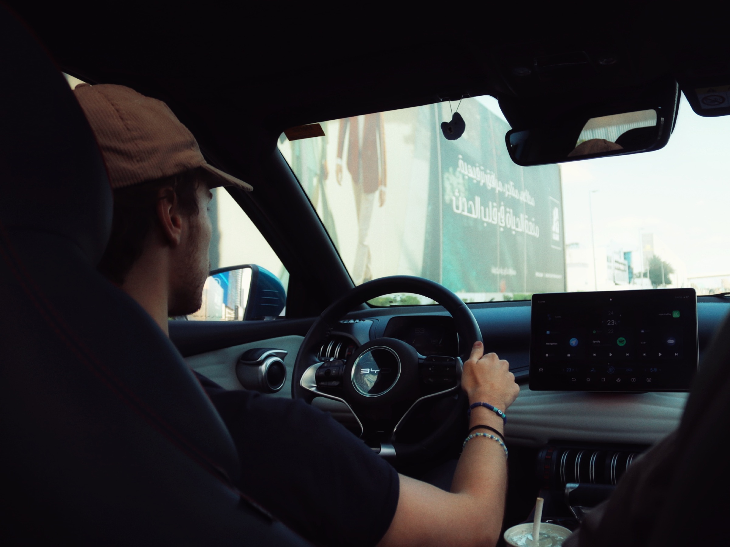 Candid interior view from the back seat of a car in traffic