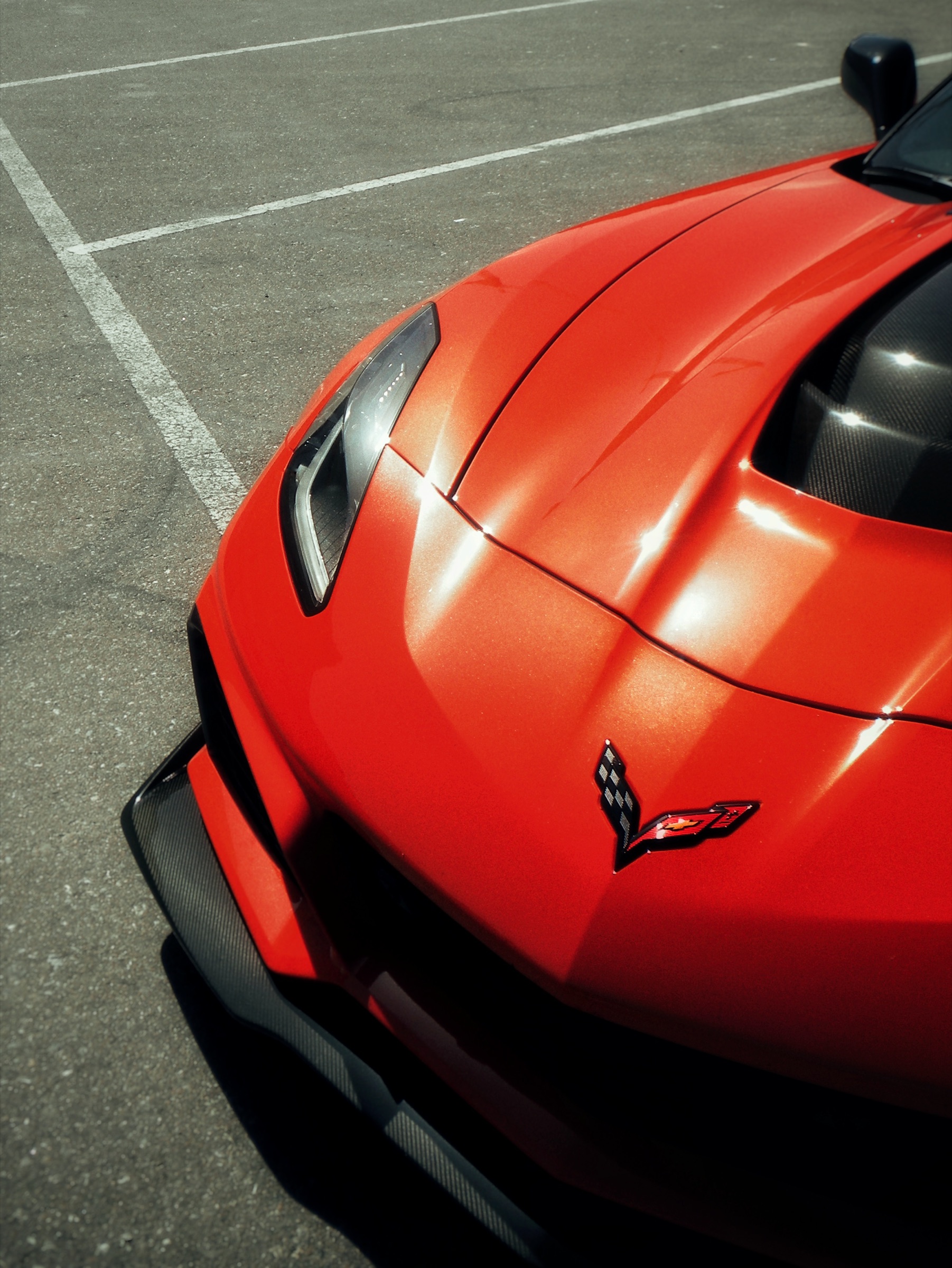 Macro study of a red car's headlight and chrome trim