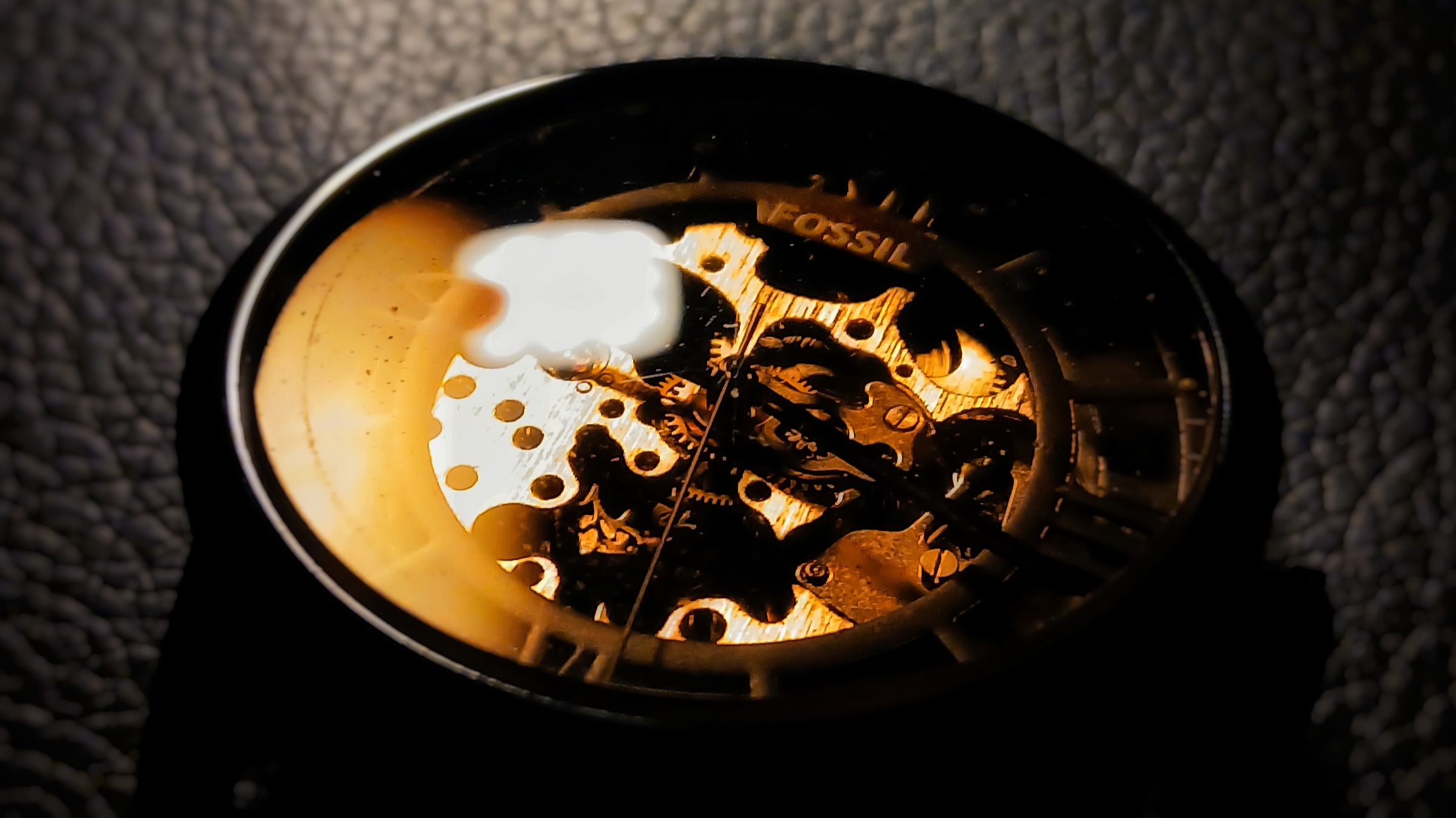 Macro study of a skeleton watch mechanism in warm light